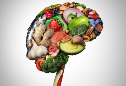 Healthy brain food to boost brainpower nutrition concept as a group of nutritious nuts fish vegetables and berries rich in omega-3 fatty acids for mind health as a composite image.