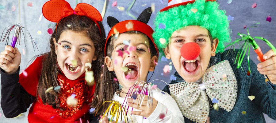 Three kids celebrating Carnival  together at home