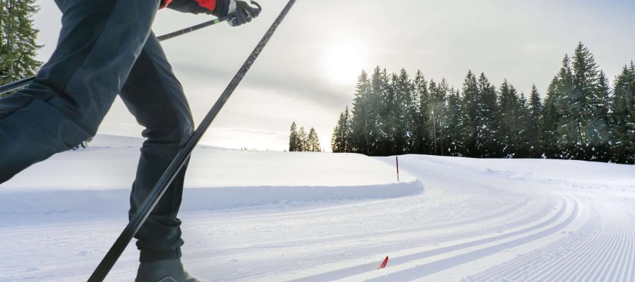 beautiful active senior woman cross-country skiing in fresh fallen powder snow in the Allgau alps near Immenstadt, Bavaria, Germany