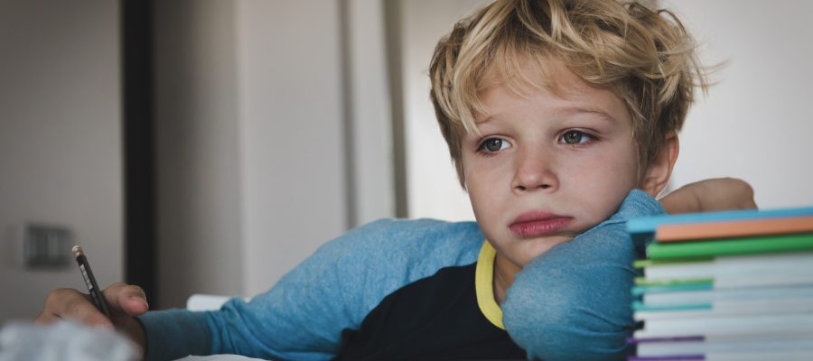 little boy tired exhausted stressed of reading, doing homework