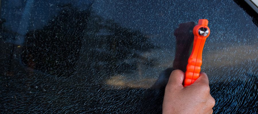 Emergency Hammer and cracked car glass Safety hammer concept